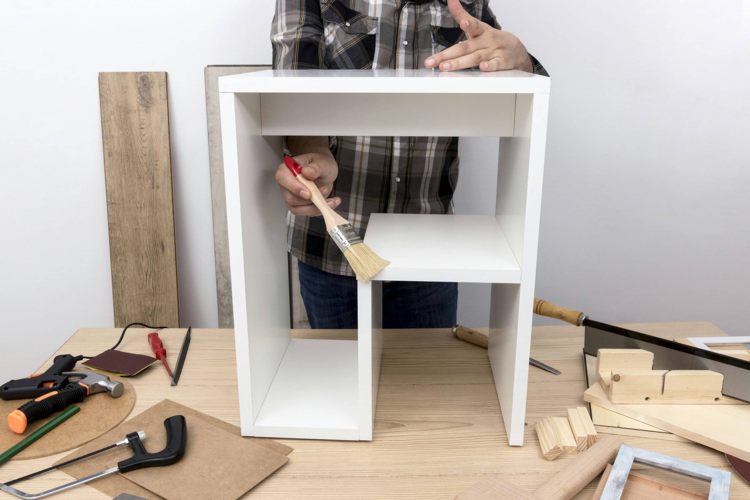 man-creating-cabinet-from-wood-front-view